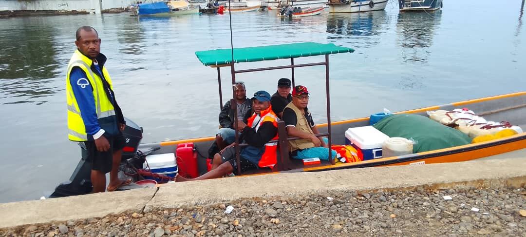 Reaching the islands — a health patrol team sets out by sea with vaccines and medical supplies for remote communities.